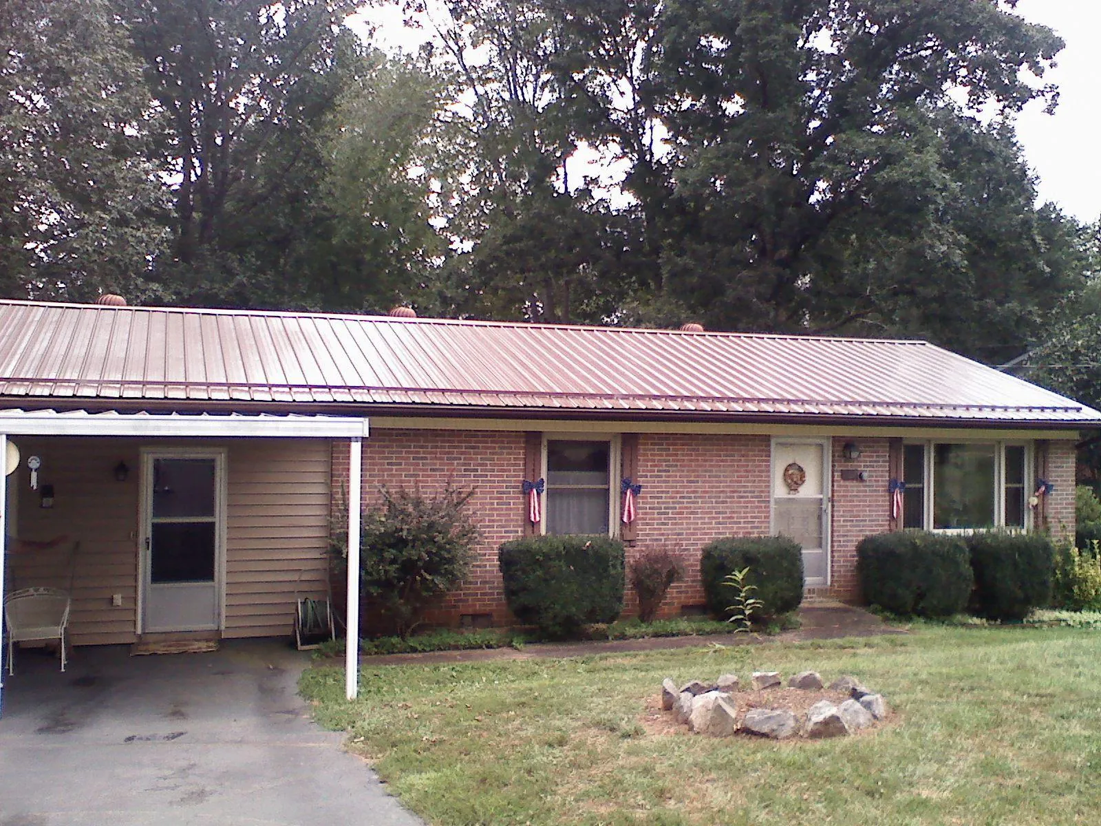 Bronze metal roof and carport on a brick ranch home — Roof Repair work by our crew in Kinzers